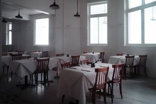 Interior of Fergus Henderson's restaurant St John Smithfield with tables laid