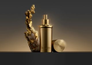 Still life image of La Prairie gold collection bottles
