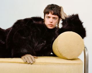 Pre Fall 2024 Best Looks Fashion Shoot featuring woman lying on modernist couch