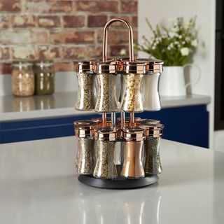 copper effect spice rack on grey countertop