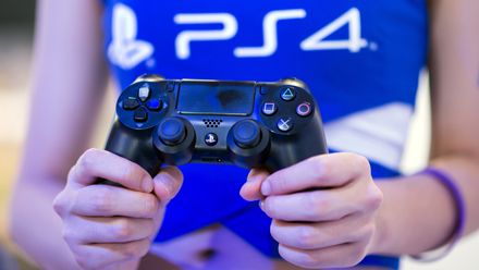 A hostess holds a remote of aPlaystation 4 at the Sony booth during the China Joy fair in Shanghai on July 31, 2014. The gamer fair China Joy (China Digital Entertainment Expo &amp;amp; Conference) o