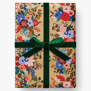 Wrapped present in floral paper with green velvet ribbon