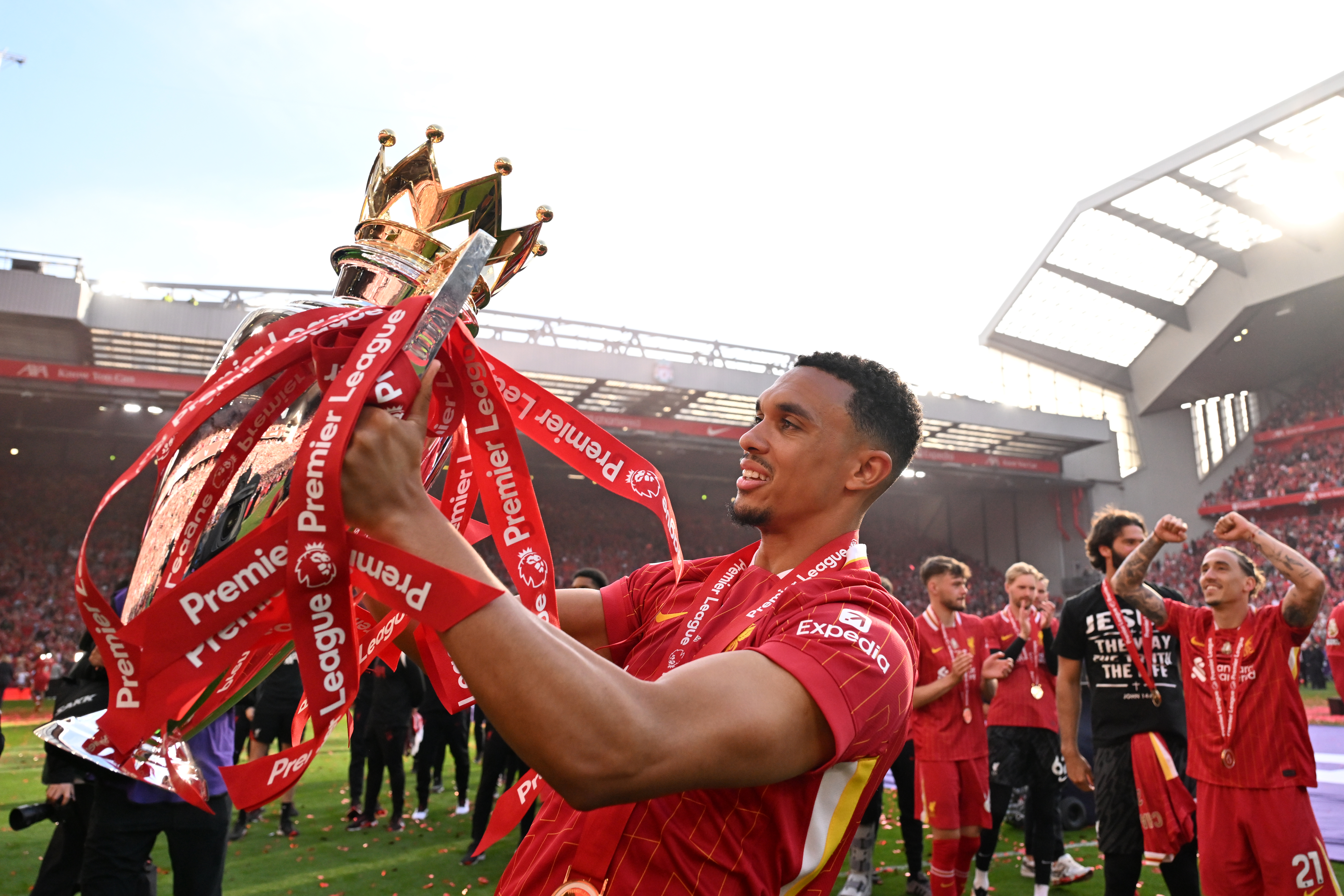 Trent Alexander-Arnold holds the Premier League trophy amid Liverpool's title celebrations at Anfield in May 2025.