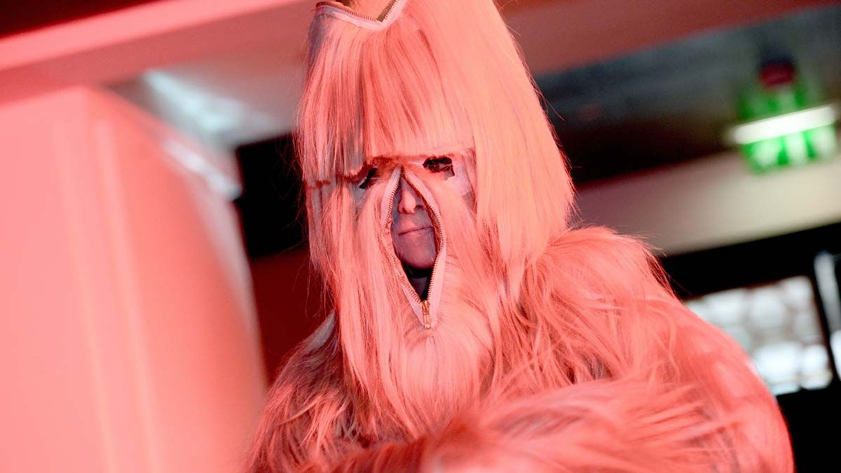 A dancer of the Crazy Horse presents a creation of French hair stylist Charlie Le Mindu on September 27, 2015 during the first edition of the Cheese Fashion Week in Paris. AFP PHOTO / STEPHAN