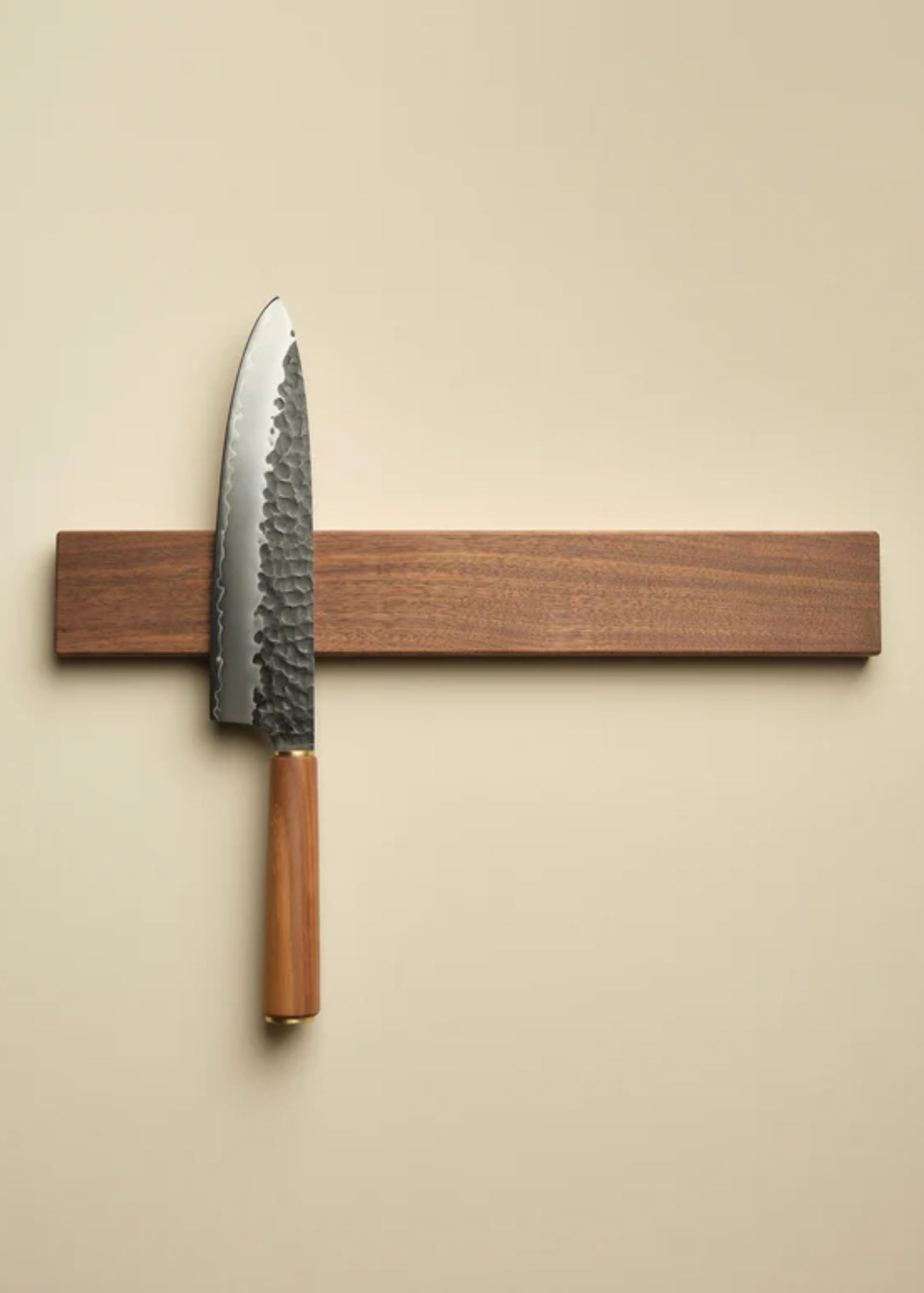 A Japanese knife on a wood magnetic block from Katto