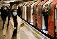 Mask-wearing commuters on the London Tube.