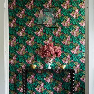 hallway with flora wallpaper and flower vase