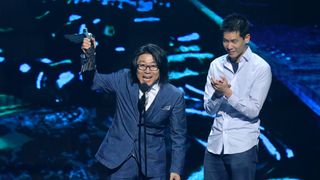 Hideaki Itsuno accepting an award.