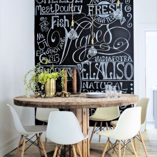 kitchen area with chalkboard and wooden dining table with chairs