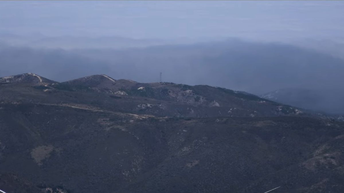 A SpaceX rocket sits on a launchpad in dense fog at Vandenberg Space Force Base.