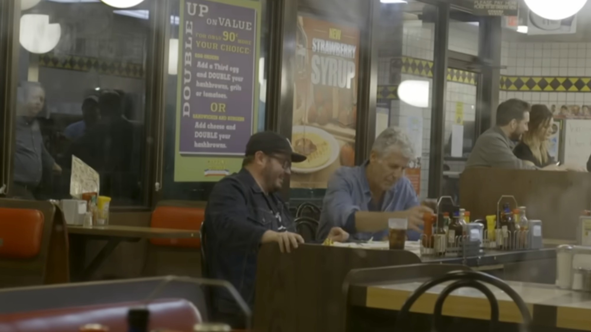 Sean Brock And Anthony Bourdain sitting at the counter in a Waffle House
