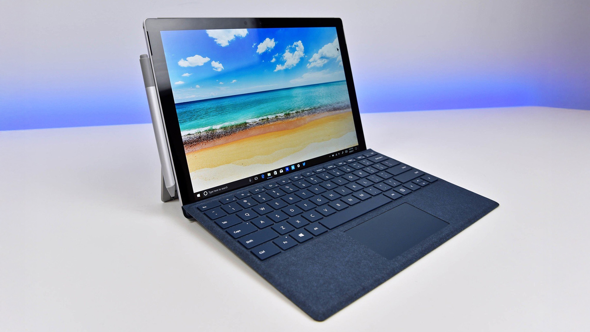Microsoft Surface Pro 5 on a white desk showing Windows 10 desktop.