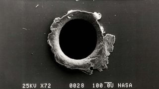 A hole punched into a satellite by space junk