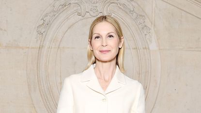 kelly rutherford on a beige background