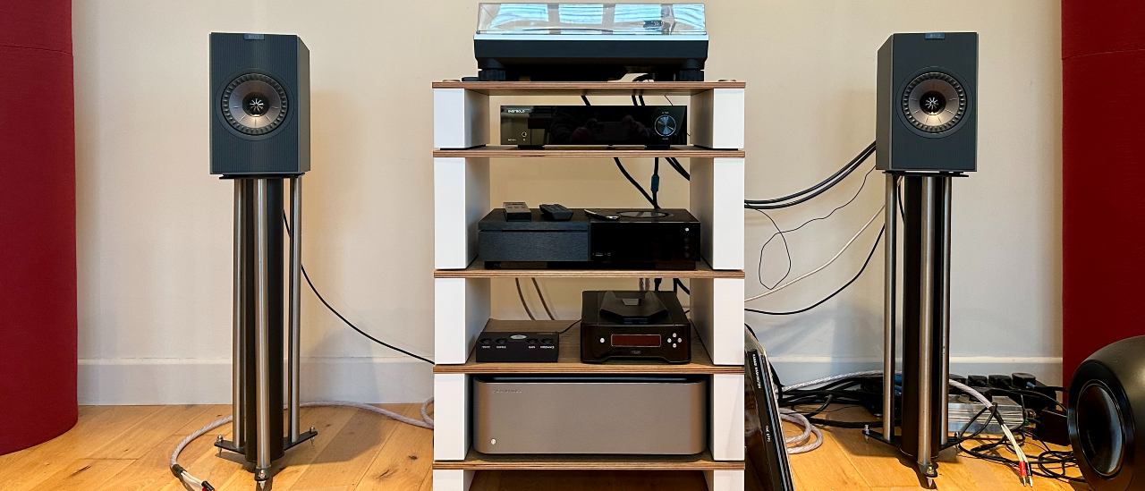 KEF Coda W active speakers, either side of an audio system, place on a pair of speaker stands.