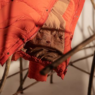 Detail of orange coat by Ten c A/W 2022