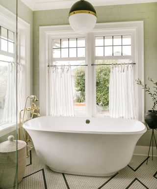White bath and window frames, tiled wall, basket