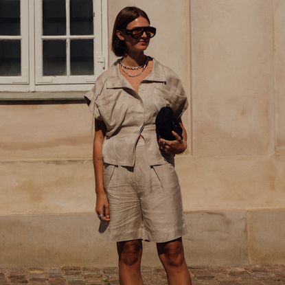 Copenhagen spring 2025 attendee wearing beige linen top and shorts with sunglasses 