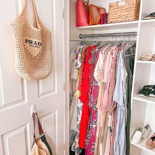 Summer wardrobe featuring colorful brights and patterns on hanging rail in closet