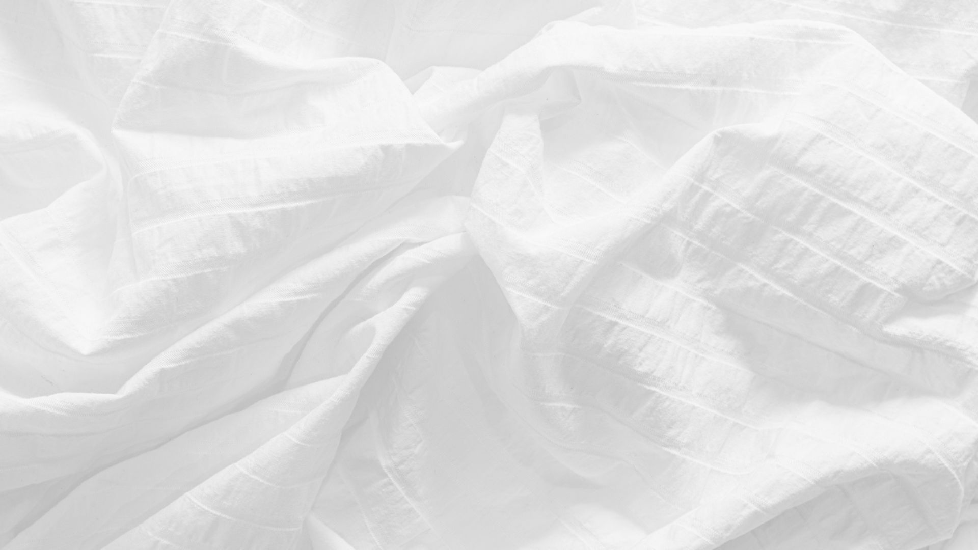A wrinkled white bed sheet made of Egyptian cotton