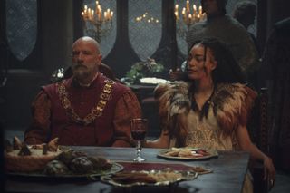 Spymaster Dijkstra and mage Philippa sit at a dining table