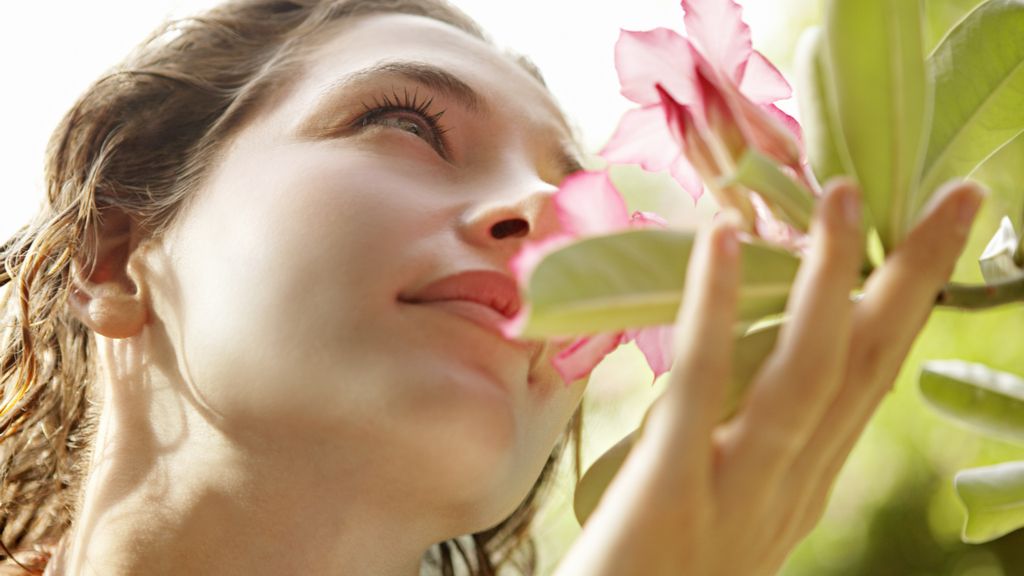 woman smelling flowers