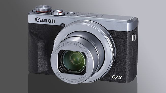 Silver Canon PowerShot G7 X Mark III, against a grey background