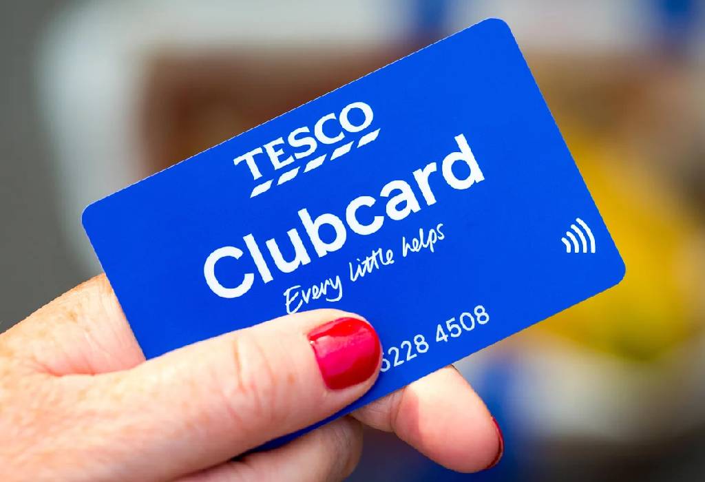 A close up of a person holding a Tesco Clubcard.