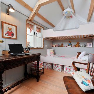 shed with white wall and wooden floor and desk