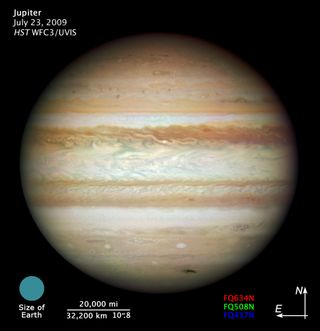 Hubble used its brand-new camera, the Wide Field Camera 3 (WFC3), to take its first full-disk natural-color image of Jupiter. It is the sharpest visible-light picture of Jupiter since the New Horizons' flyby in 2007. The dark smudge at bottom right repres