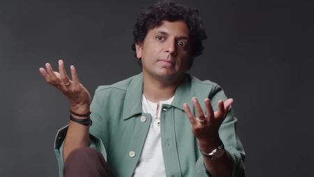 M. Night Shyamalan is shown during an interview with GQ.