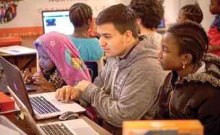 HackSchool student founder, Carlos Fernandez, facilitates a coding workshop with middle- and elementary-school students at the Village Exchange Center in Aurora, CO.