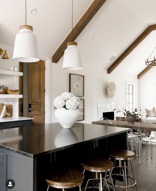 a kitchen with exposed beams