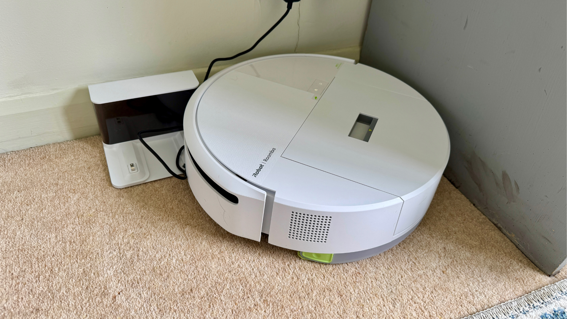 iRobot Roomba 205 DustCompactor Combo robot vacuum tangled in its own dock's charge cord