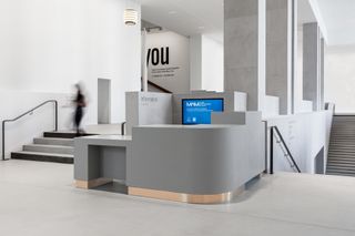 White/grey reception area with black computer