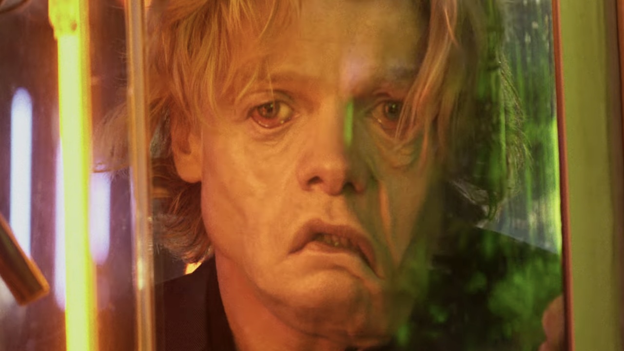 Matt Hagen's face melting through store window in Clayface