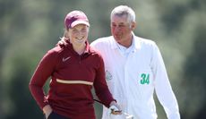Lottie Woad and her caddie celebrate on the 18th green