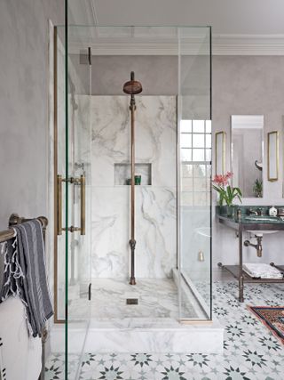 shower enclosure with marble and exposed shower controls