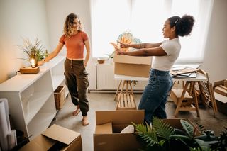 Two university students decorating their uni home.