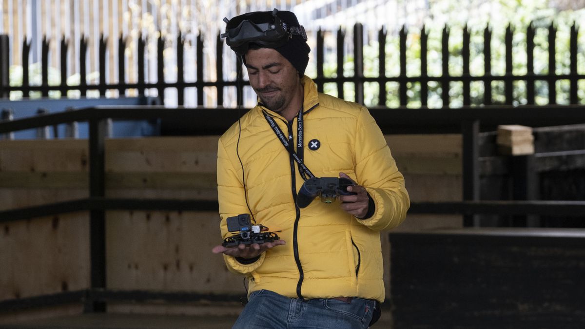 A man holding the GoPro Hero 10 Black Bones camera on a drone