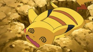 Pikachu fainted, looking worn out on the ground in the Pokemon anime.
