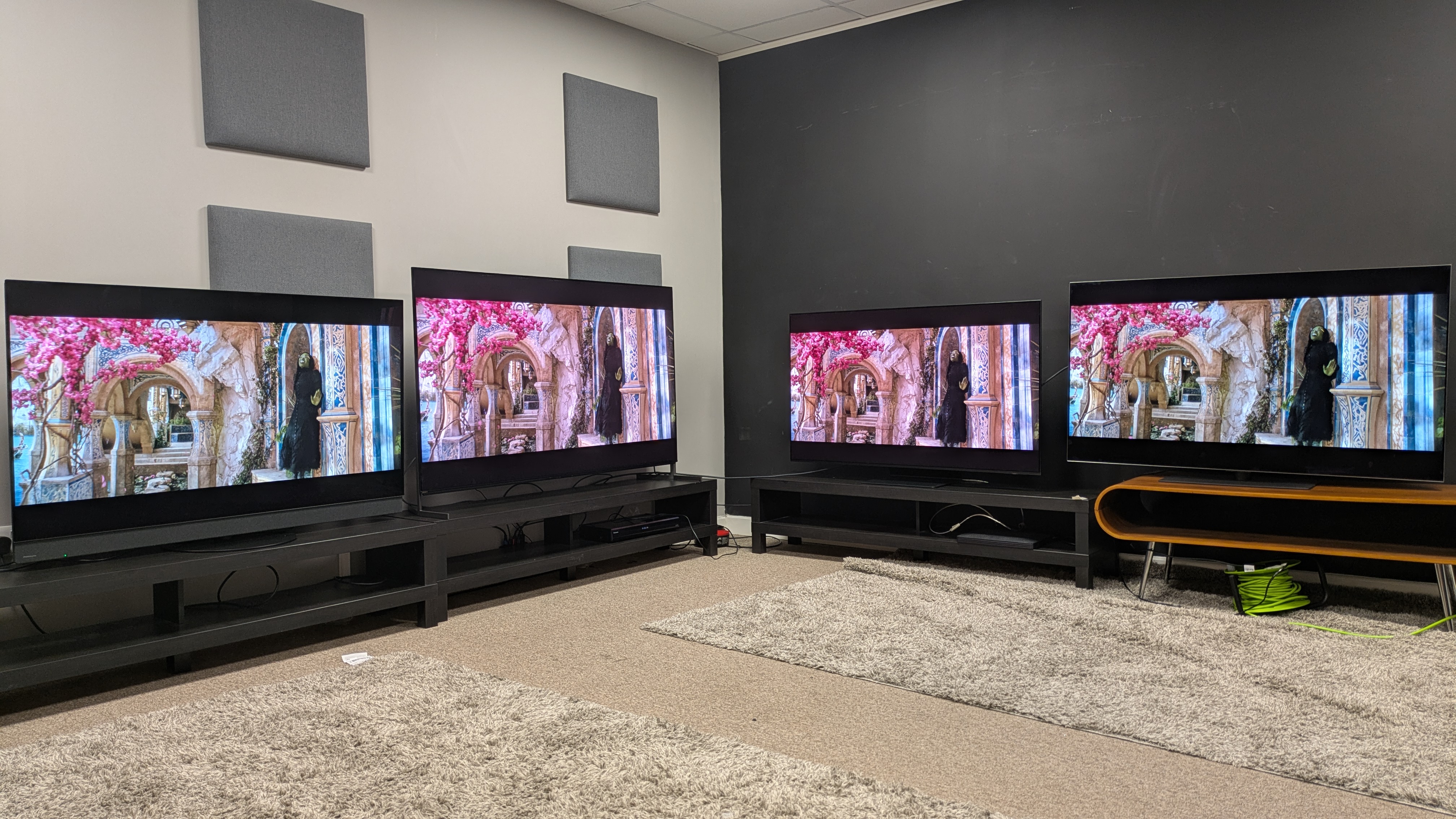 Panasonic Z95B (far left) Sony Bravia 8 II (middle left) Samsung S95F (middle right) LG G5 (far right) with Elphaba from Wicked on screen