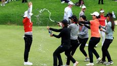 Amy Yang of South Korea is showered with champagne by fellow players after winning the KPMG Women's PGA Championship at Sahalee Country Club last year