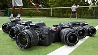 A row on six DSLR cameras on a tennis court