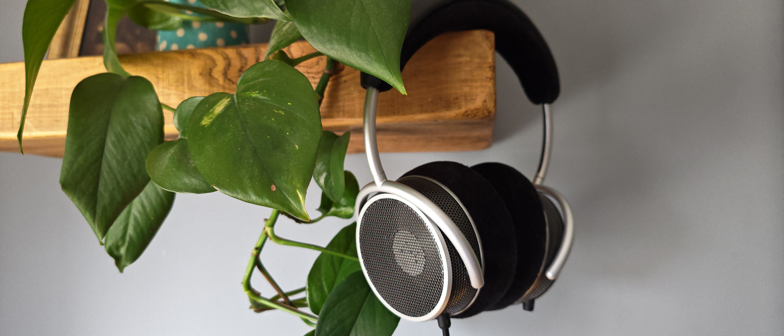 The Grell OAE2 headphone, hanging from a wooden shelf. 