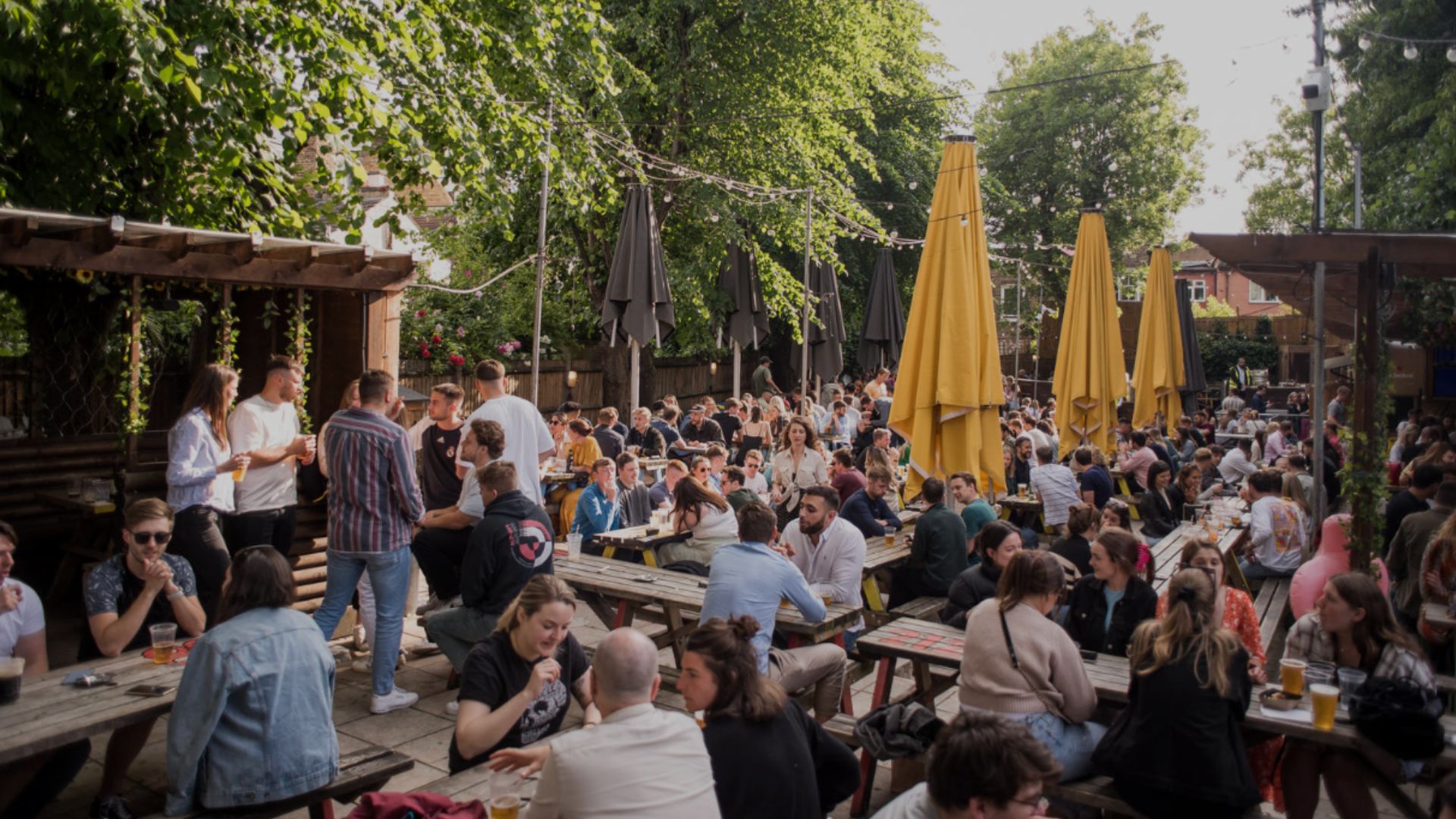 an image of the duke of edinburgh pub garden which is filled with people on benches