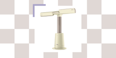 A butter yellow bladeless multi-directional fan from Shark against a checkerboard focus background