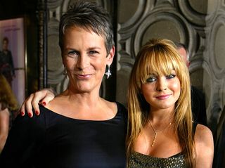 Actress Jamie Lee Curtis (L) and actress Lindsay Lohan (R), stars of the new Disney film "Freaky Friday," pose before the premiere of the movie at the El Capitan theater August 4, 2003 in Hollywood, California