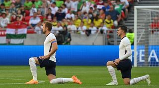 Harry Kane and Mason Mount take the knee before England's UEFA Nations League game against Hungary in Budapest.