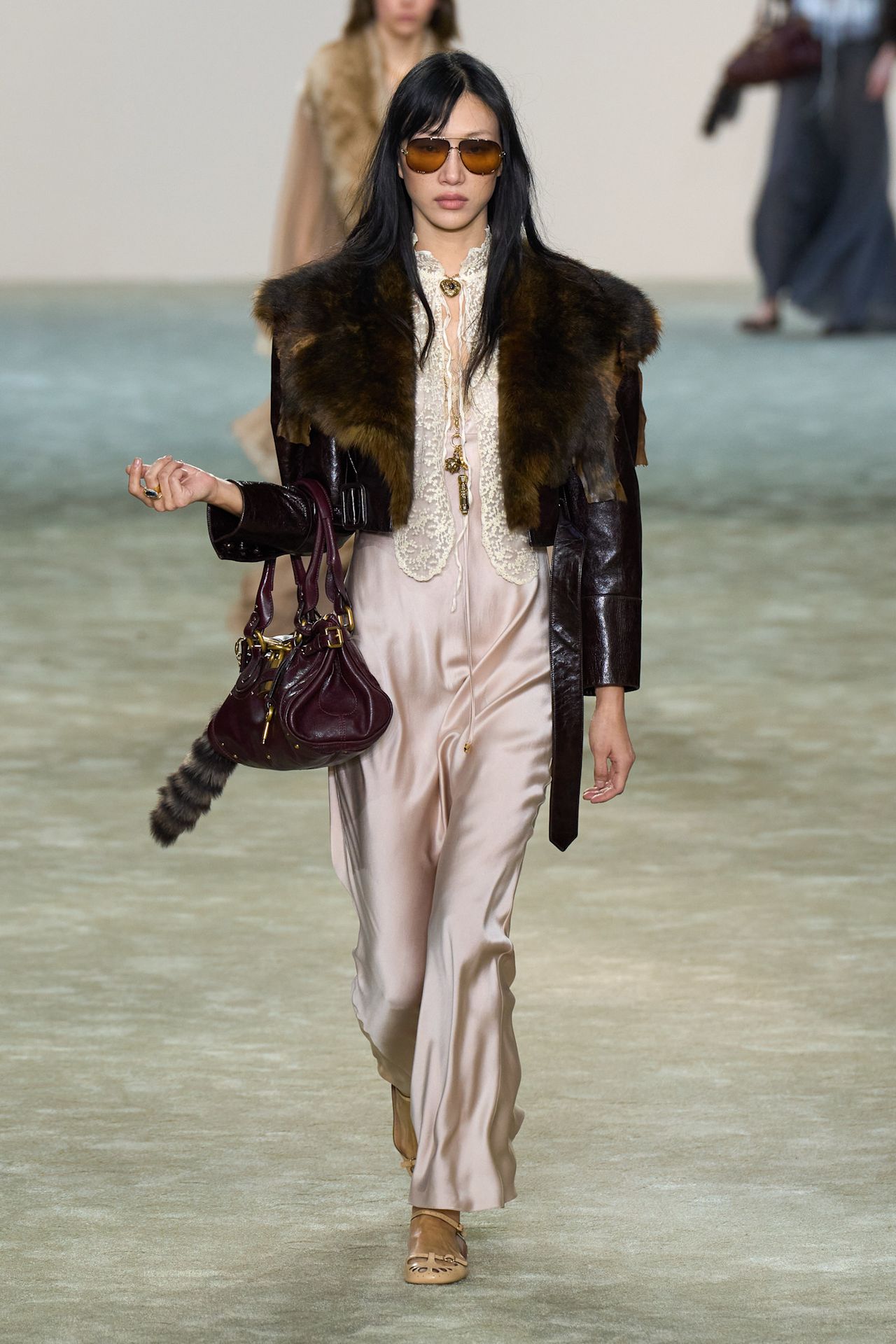 A Chlo&eacute; model at the F/W 25 show wearing a leather-and-fur jacket with a silk-and-lace slip dress.